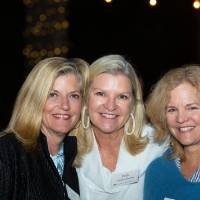 Three women smiling for camera
